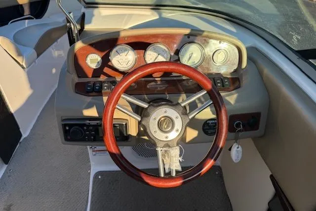 Slide: The Image of 2010 Regal 2300 Bowrider dashboard with wooden steering wheel and instrument panel. - 7