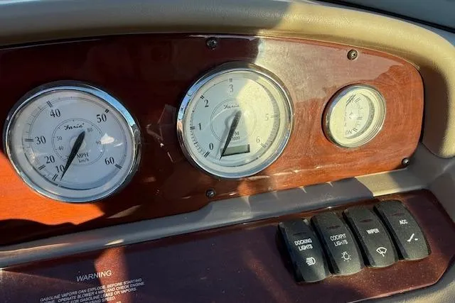 Slide: The Image of Dashboard of 2010 Regal 2300 Bowrider with gauges and control switches. - 9