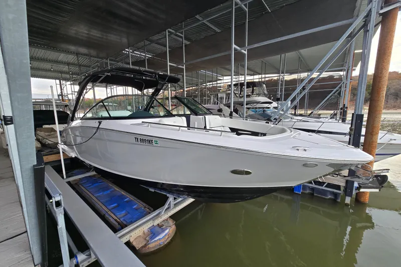 The Image of 2021 Regal 2800 Bowrider boat docked in a marina, side view. - 0