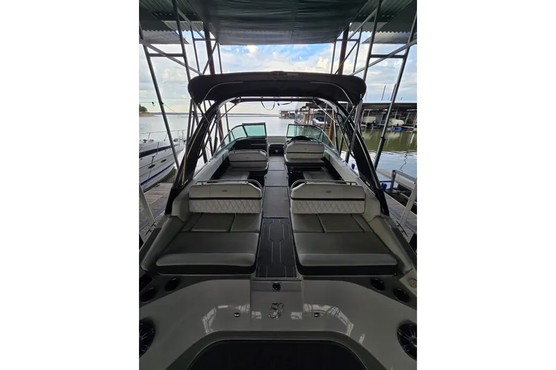 Slide: The Image of 2021 Regal 2800 Bowrider boat interior, docked, showcasing spacious seating and sleek design. - 10