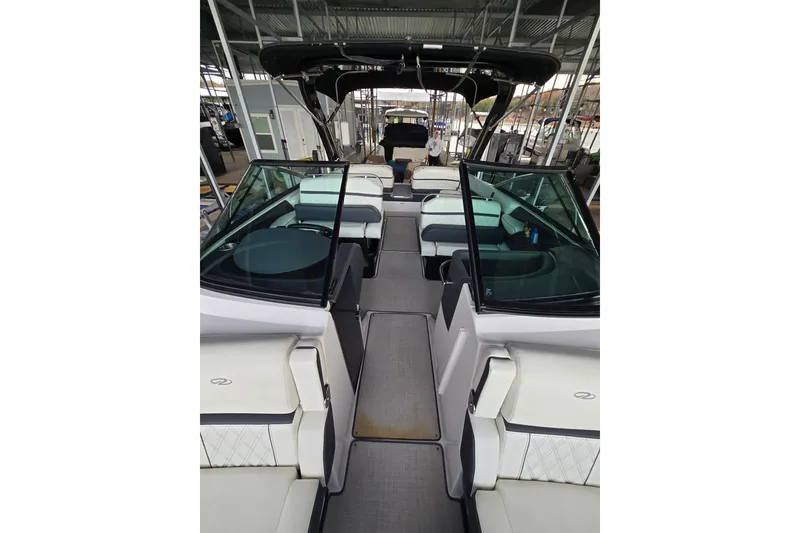 Slide: The Image of 2021 Regal 2800 Bowrider boat interior with seating and canopy. - 12
