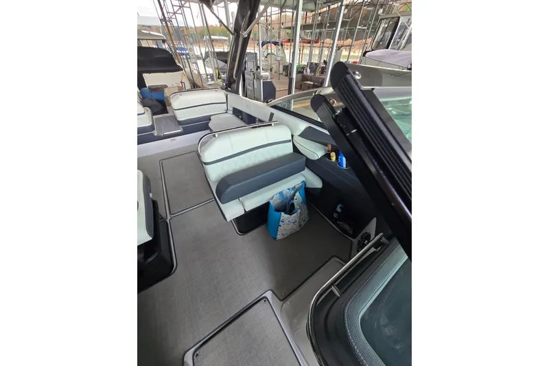 Slide: The Image of 2021 Regal 2800 Bowrider interior with seating and storage, docked at marina. - 13