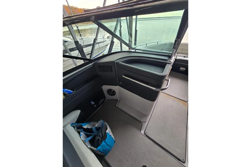 Slide: The Image of Interior of a 2021 Regal 2800 Bowrider boat with seating and storage. - 16