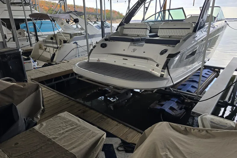 Slide: The Image of 2021 Regal 2800 Bowrider docked in a marina, showcasing sleek design and spacious seating. - 2