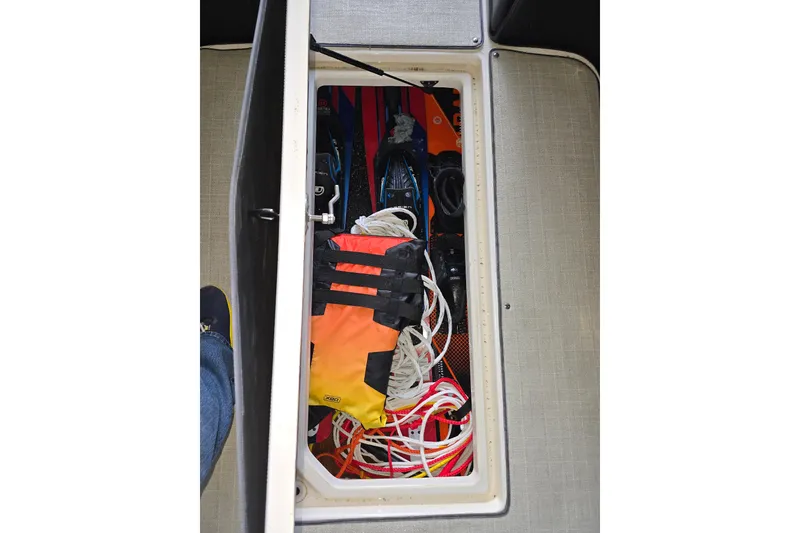 Slide: The Image of Storage compartment in 2021 Regal 2800 Bowrider with life jacket and ropes. - 26
