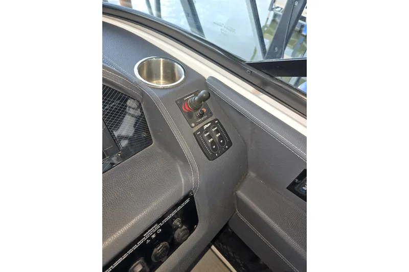 Slide: The Image of 2021 Regal 2800 Bowrider dashboard with joystick control and cup holder. - 27