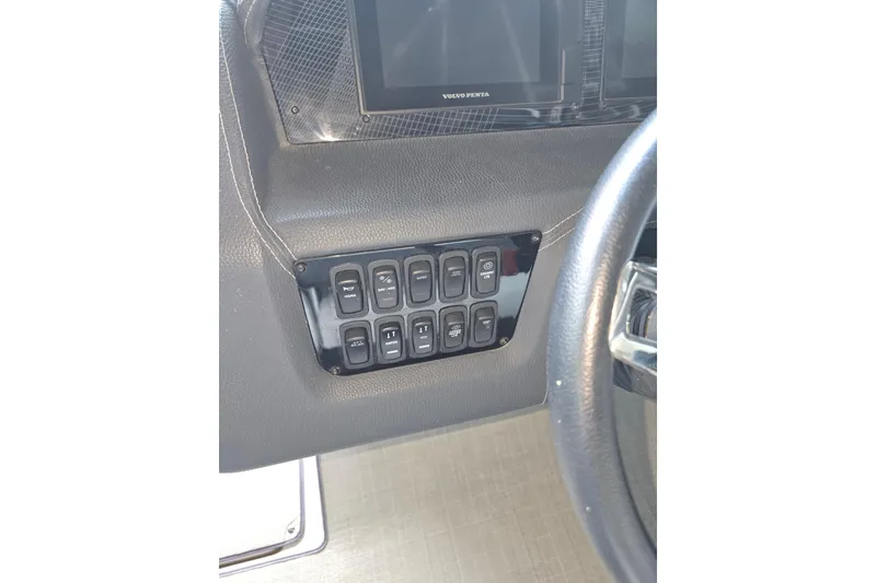 Slide: The Image of 2021 Regal 2800 Bowrider dashboard with control panel and steering wheel. - 30