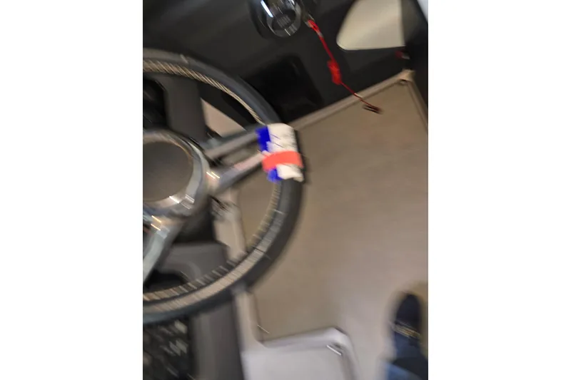 Slide: The Image of Steering wheel of 2021 Regal 2800 Bowrider boat, featuring modern design elements. - 31