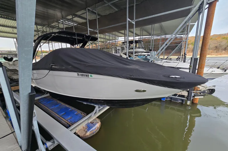 Slide: The Image of 2021 Regal 2800 Bowrider boat covered and docked in a marina. - 37