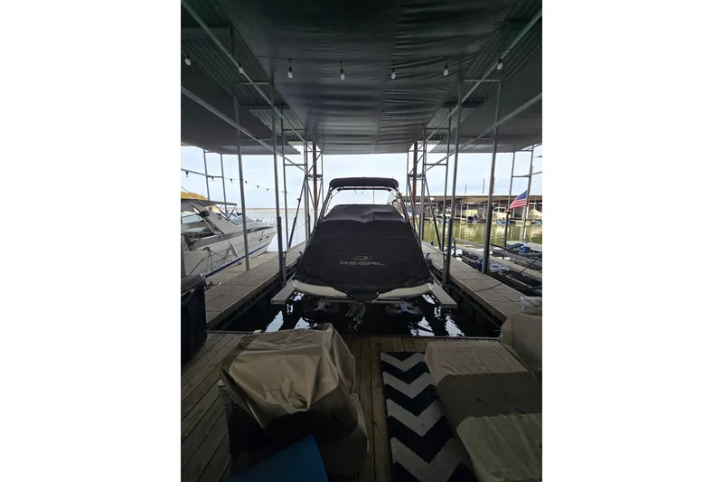 Slide: The Image of 2021 Regal 2800 Bowrider docked under covered marina, rear view. - 39