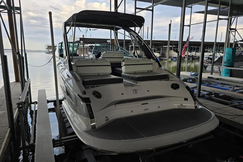 Slide: The Image of 2021 Regal 2800 Bowrider docked in a marina, rear view. - 5