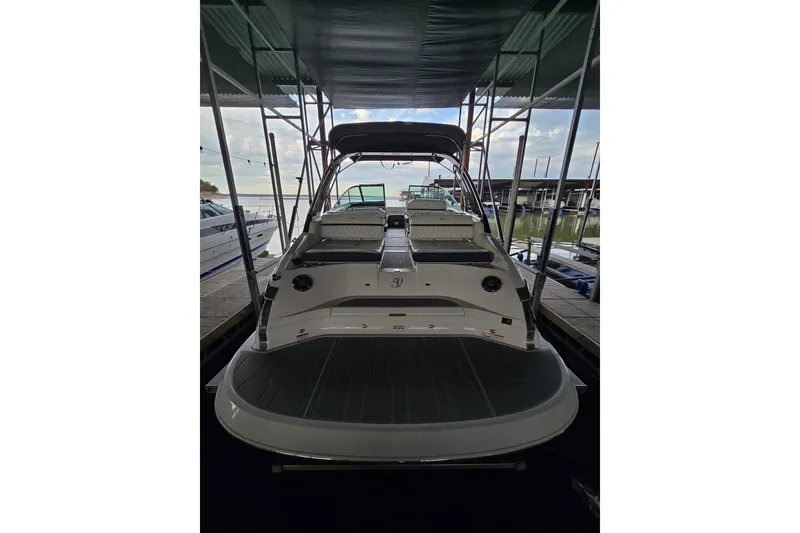 Slide: The Image of 2021 Regal 2800 Bowrider boat docked under a canopy. - 9