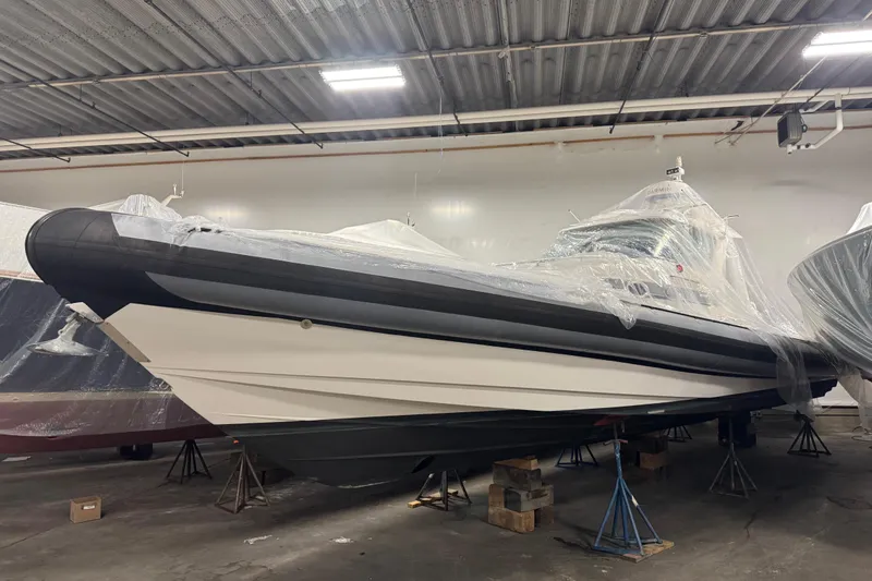 Slide: The Image of 2016 Protector Tauranga 41 boat in storage, covered with protective plastic wrap. - 12