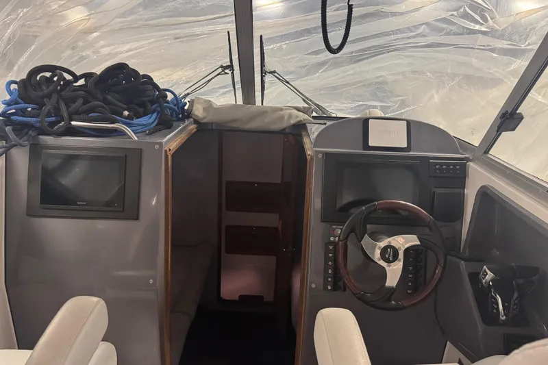Slide: The Image of Interior of 2016 Protector Tauranga 41 boat with steering wheel and navigation equipment. - 6