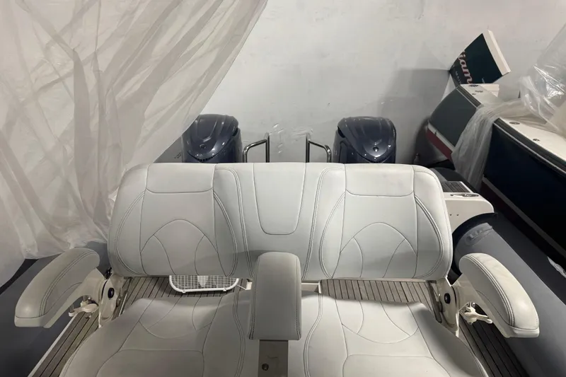 Slide: The Image of White leather boat seating on a 2016 Protector Tauranga 41, with engines in the background. - 7