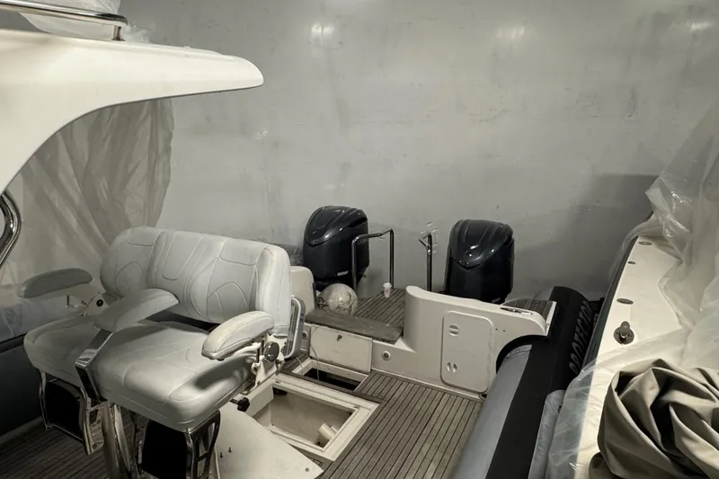 Slide: The Image of Interior of a 2016 Protector Tauranga 41 boat with seating and dual engines. - 9
