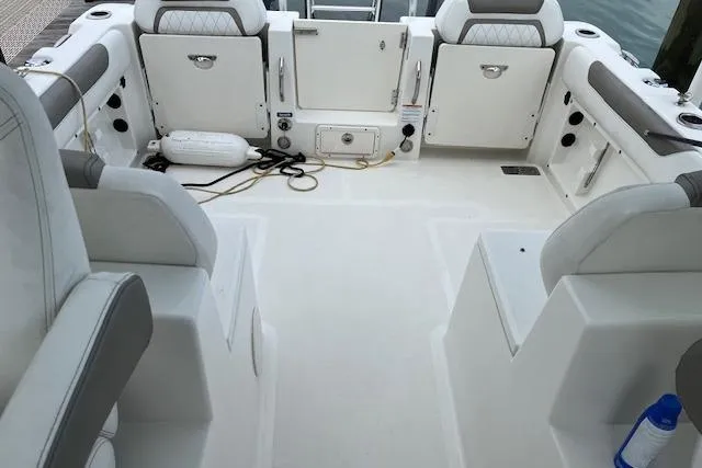 Slide: The Image of 2022 World Cat 255 DC boat interior with seating and storage compartments. - 12