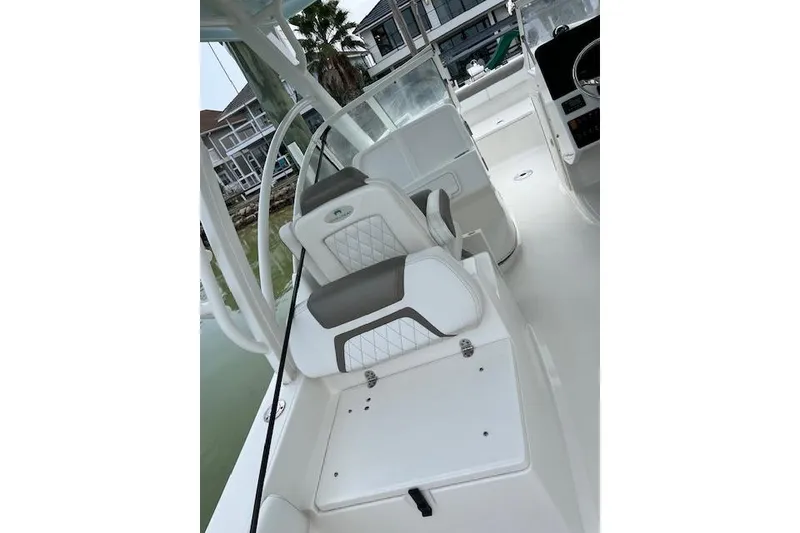 Slide: The Image of 2022 World Cat 255 DC boat interior with white seating and modern design. - 13