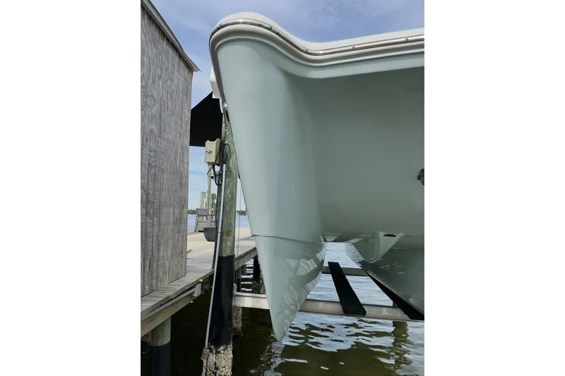 Slide: The Image of 2022 World Cat 255 DC boat docked at marina, showcasing sleek design and seating. - 3