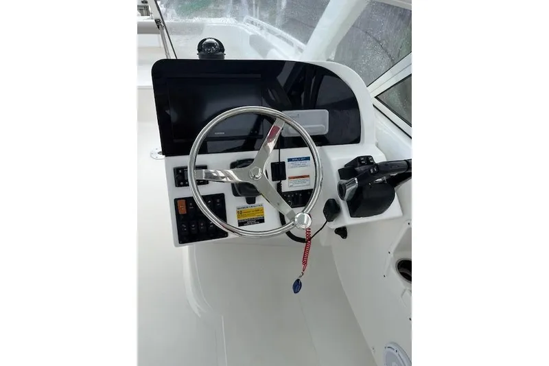 Slide: The Image of Steering console of 2022 World Cat 255 DC boat with modern controls and display. - 6