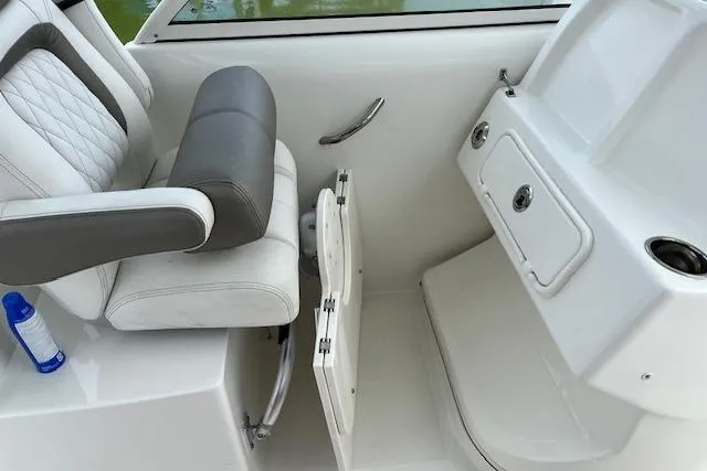 Slide: The Image of 2022 World Cat 255 DC boat interior with seating and storage compartment. - 7