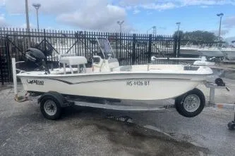 The Image of 2022 Mako Pro Skiff 15 CC boat on trailer, parked outdoors. - 1