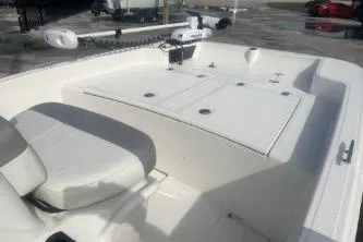 Slide: The Image of 2022 Mako Pro Skiff 15 CC boat interior with seating and storage compartments. - 10