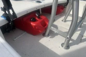 Slide: The Image of 2022 Mako Pro Skiff 15 CC boat interior with red fuel tank and metal supports. - 11