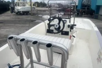 Slide: The Image of 2022 Mako Pro Skiff 15 CC boat with center console and rod holders. - 9