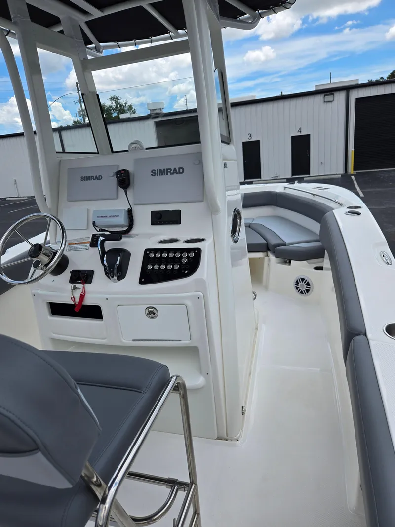 Slide: The Image of 2023 NauticStar 242L Offshore boat interior with helm and seating. - 11