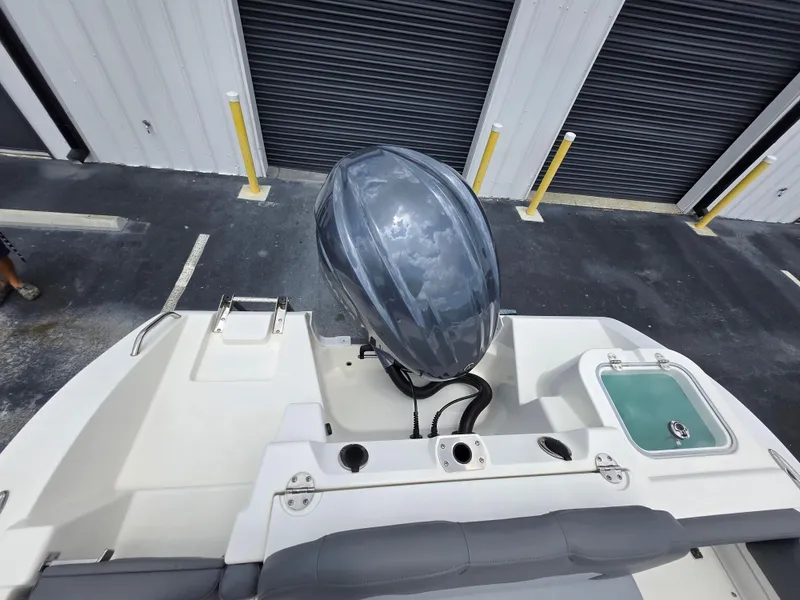 Slide: The Image of 2023 NauticStar 242L Offshore boat with outboard motor in storage facility. - 21