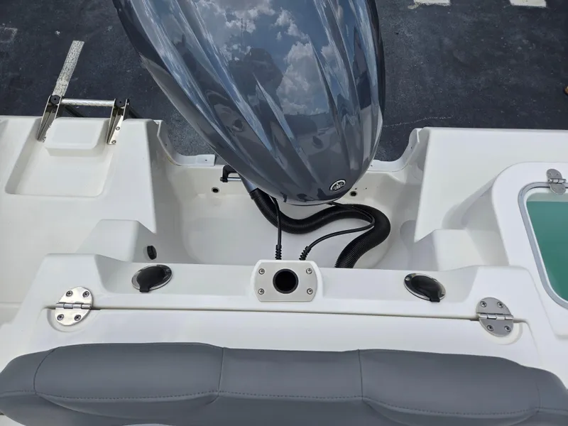 Slide: The Image of 2023 NauticStar 242L Offshore boat engine and seating area. - 8