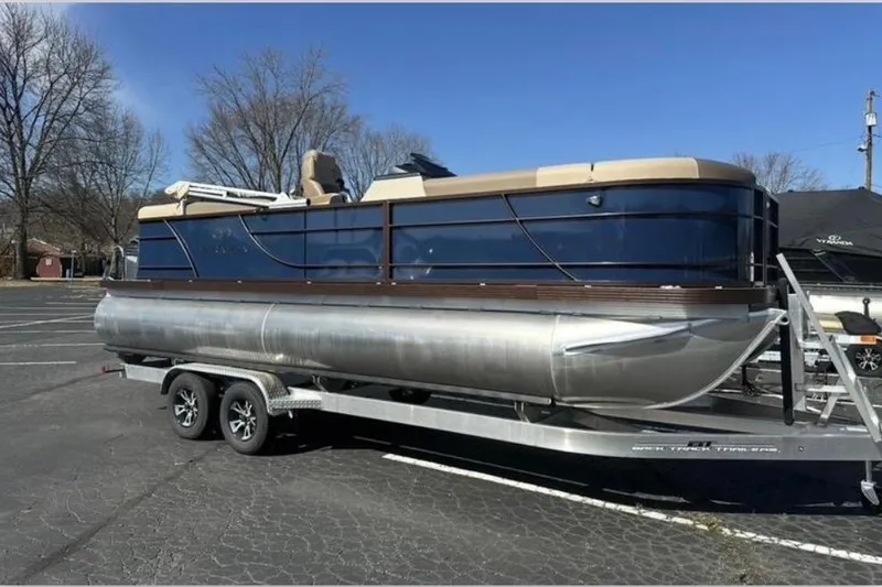 The Image of 2025 Veranda Relax VR 22 RC pontoon boat on trailer in parking lot. - 1