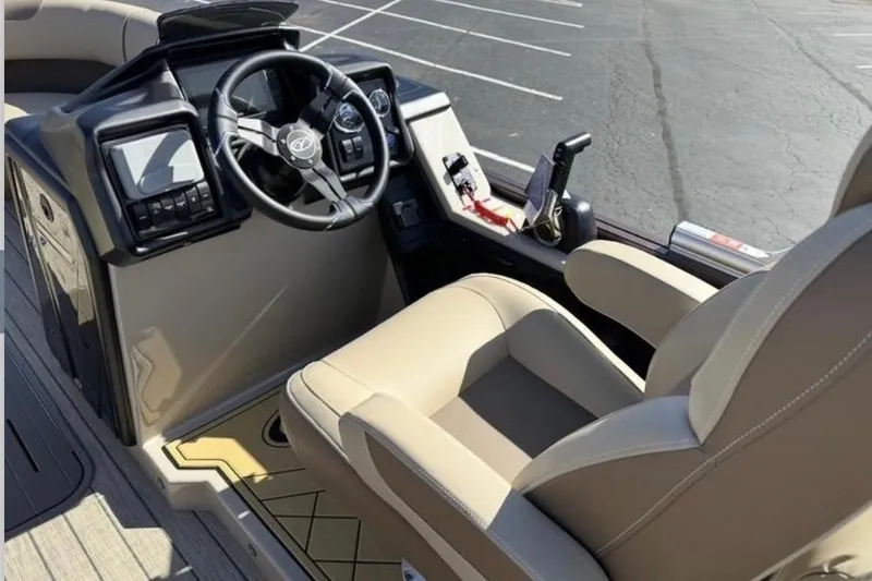 Slide: The Image of 2025 Veranda Relax VR 22 RC boat interior with steering wheel and beige seating. - 5
