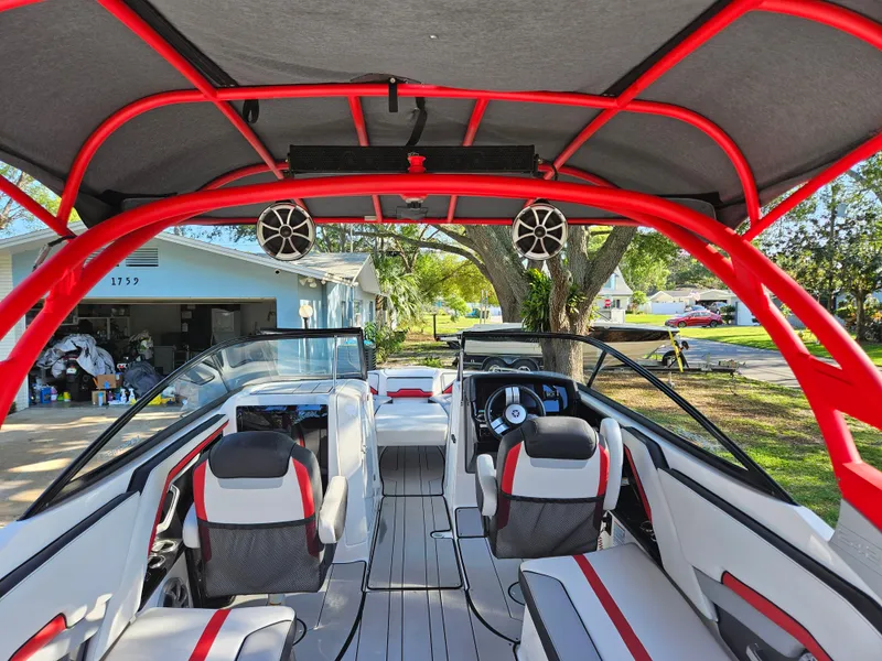 Slide: The Image of 2020 Yamaha Boats 242X interior with red accents and modern seating. - 17