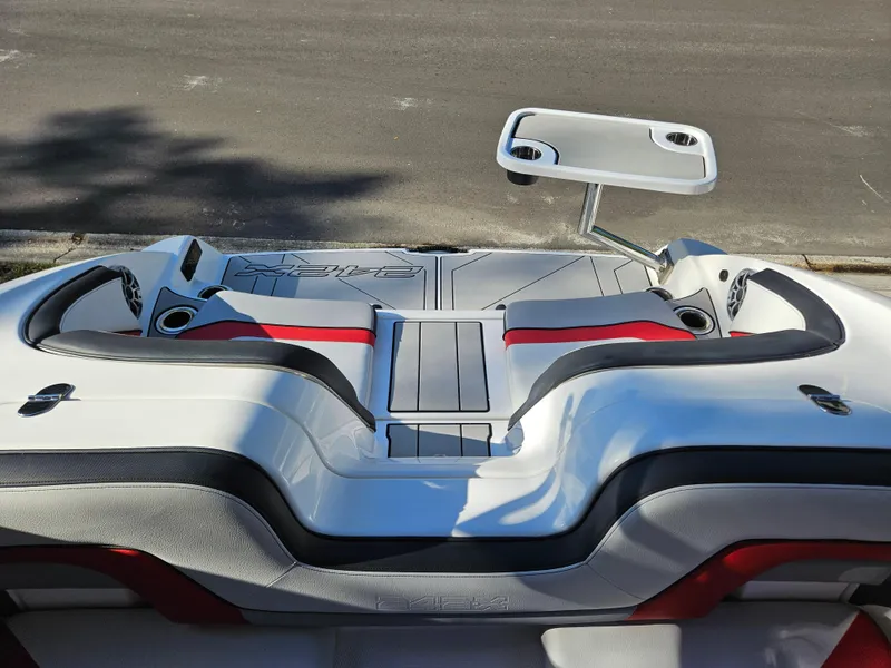 Slide: The Image of 2020 Yamaha Boats 242X rear seating area with table and cup holders. - 20