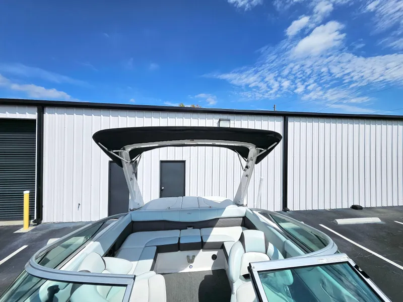 Slide: The Image of 2014 Regal 2100 Bowrider boat with bimini top in storage facility. - 10