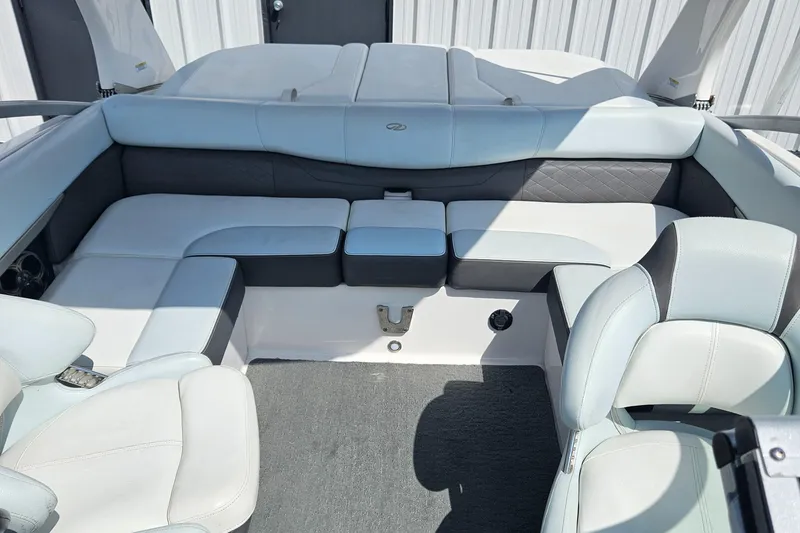 Slide: The Image of 2014 Regal 2100 Bowrider boat interior with white and gray seating. - 14