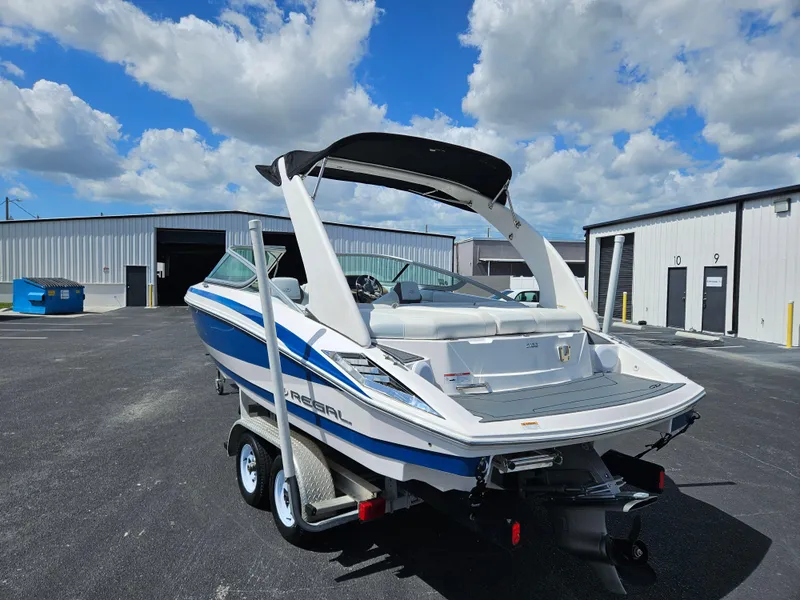 Slide: The Image of 2014 Regal 2100 Bowrider boat on trailer, parked outside storage facility. - 3