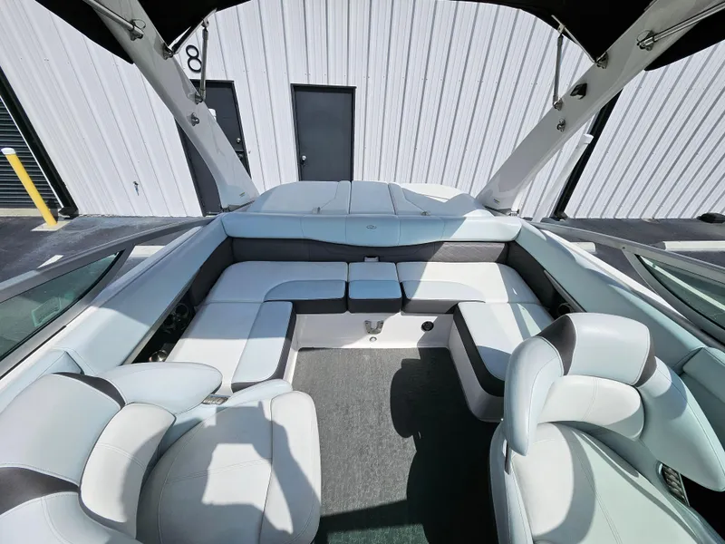 Slide: The Image of 2014 Regal 2100 Bowrider boat interior with white and gray seating. - 6