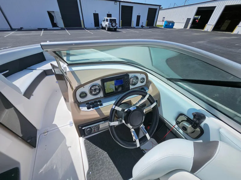 Slide: The Image of 2014 Regal 2100 Bowrider boat interior with steering wheel and dashboard controls. - 9