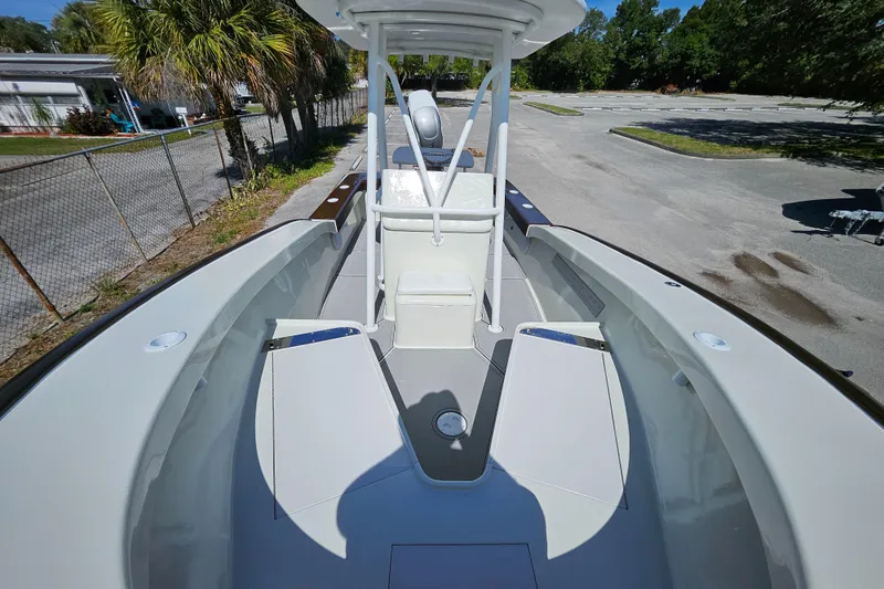 Slide: The Image of 2023 Carolina Classic 25 boat deck with seating and helm station. - 15