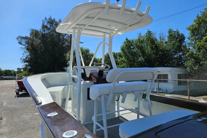 Slide: The Image of 2023 Carolina Classic 25 boat with white seating and canopy. - 16