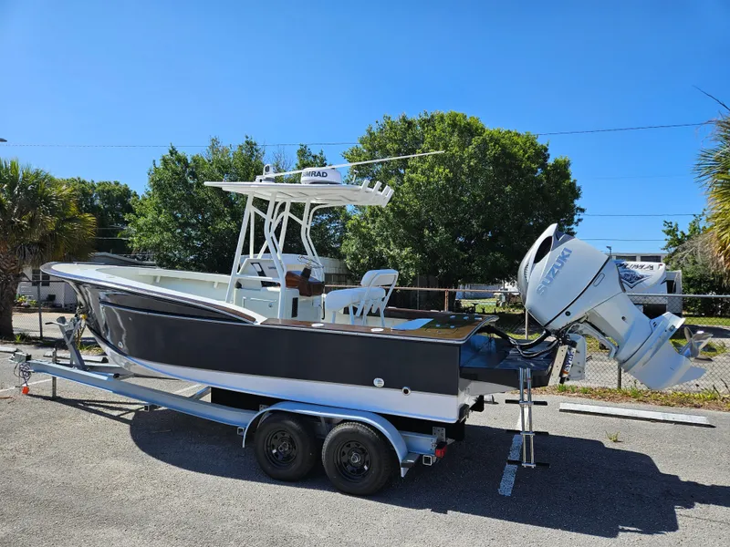 Slide: The Image of 2023 Carolina Classic 25 boat on a trailer with outboard motor. - 5