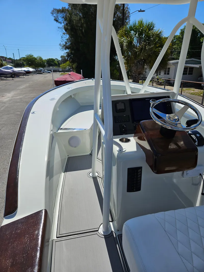 Slide: The Image of 2023 Carolina Classic 25 boat cockpit with steering wheel and control panel. - 7