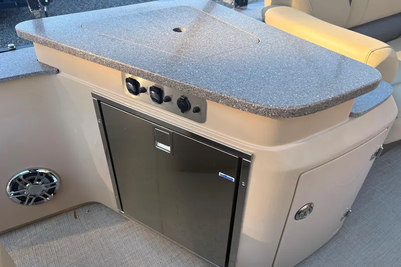 Slide: The Image of 2022 Avalon Excalibur Elite Windshield boat interior with sleek countertop and storage. - 10