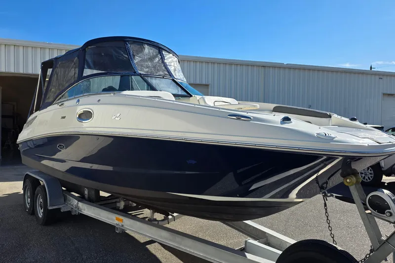 Slide: The Image of 2010 Sea Ray 260 Sundeck boat on trailer, parked outside a warehouse. - 29