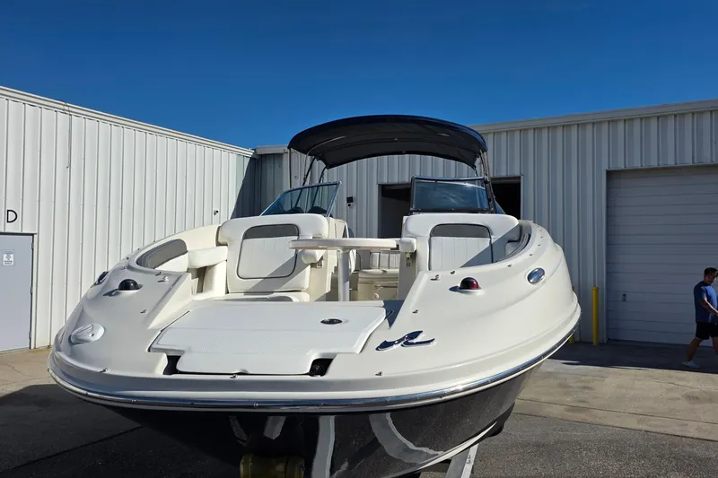 Slide: The Image of 2010 Sea Ray 260 Sundeck boat at a marina, front view. - 37