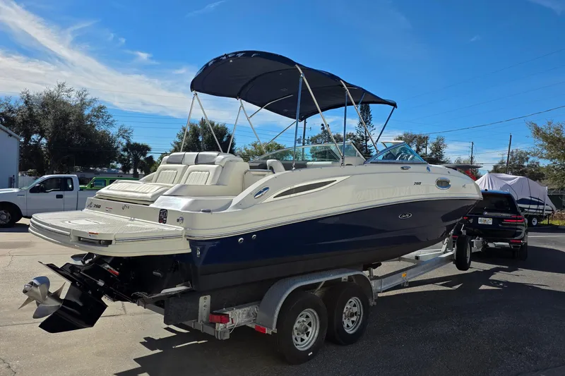 Slide: The Image of 2010 Sea Ray 260 Sundeck boat on trailer, featuring sleek design and spacious seating. - 57