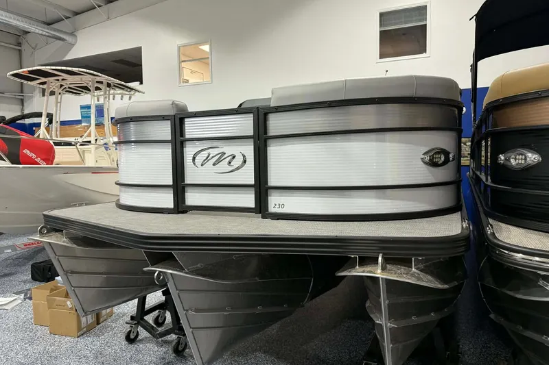 The Image of 2026 Manitou Encore SL 230 SHP pontoon boat in showroom display. - 0